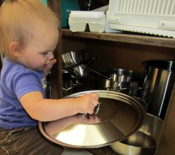 Samantha playing with pots and pans